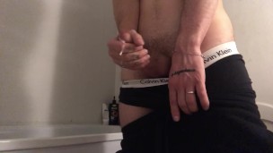 A guy in sweatpants jerked off his dick and cumshot
