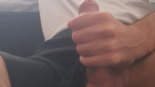 young guy in sports shorts jerks off and cums on himself