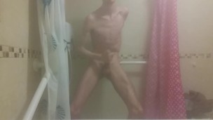 Skinny boy strokes his big wet cock after shower