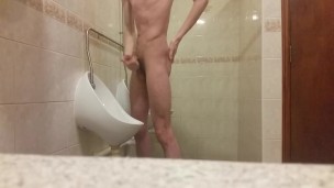 Very skinny teen masturbates in public bathroom urinal